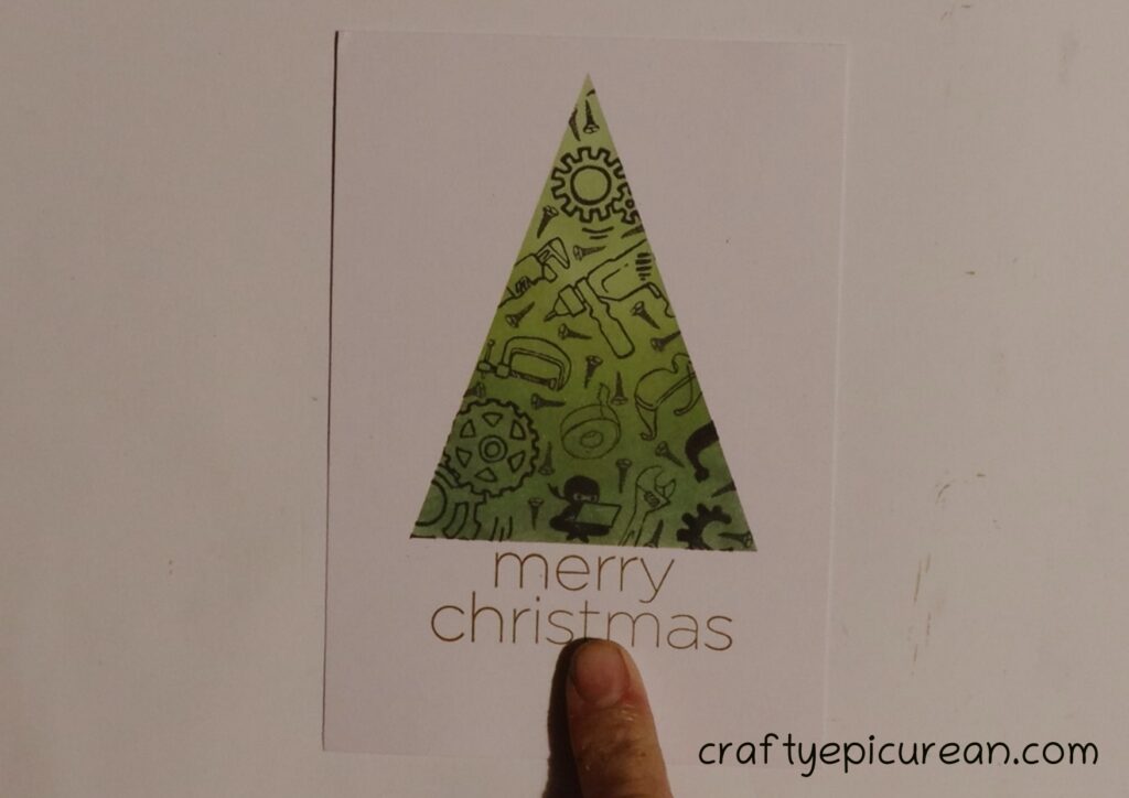 Stamping 'Merry Christmas' below the tree