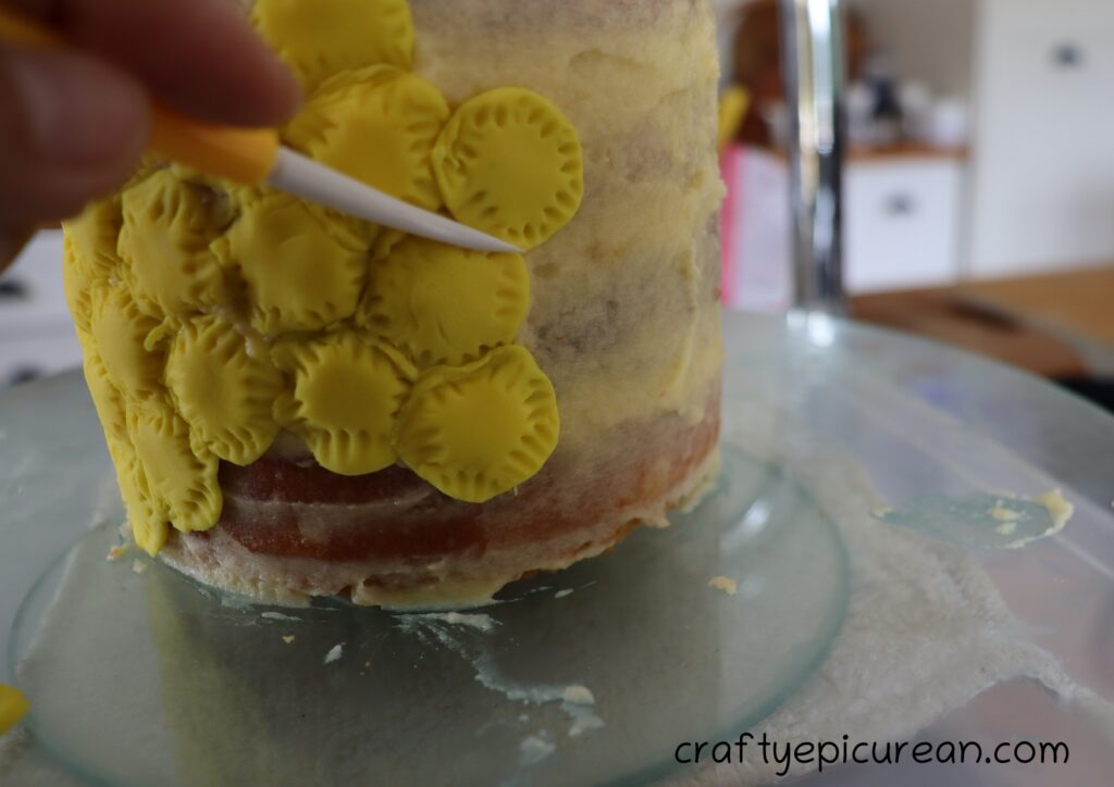 Assembing fondant onto Cake